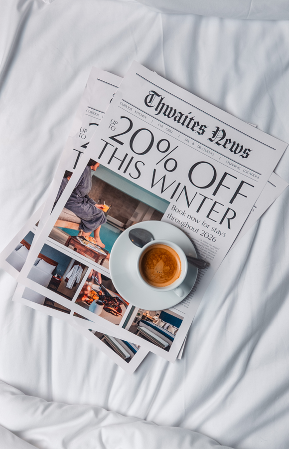 "up to 20% off this winter" newspaper on a bed with a coffee