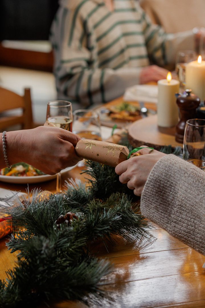 two people pulling a Christmas cracker